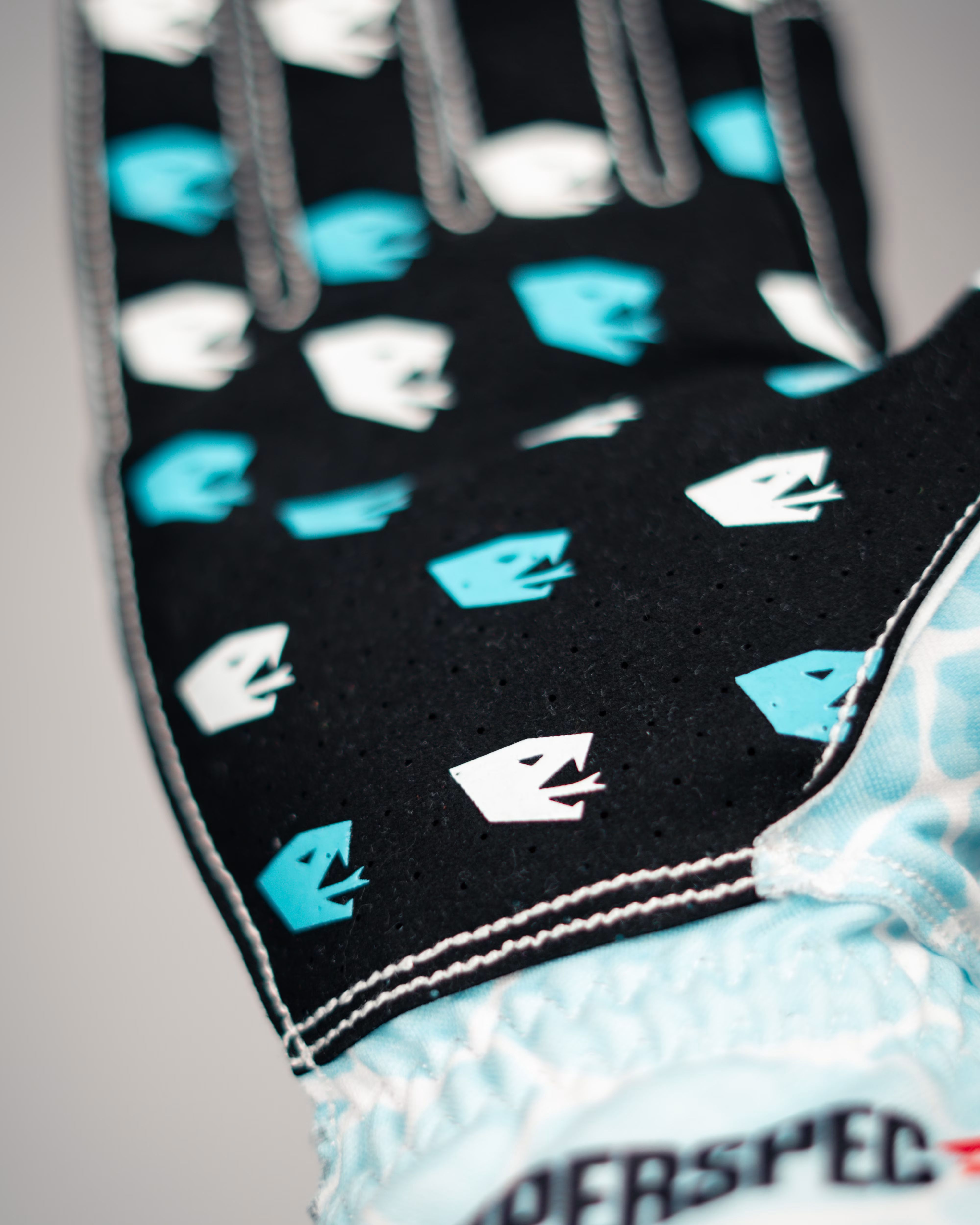 Close-up of the V2 Ice Serpent palm: black perforated fabric printed with blue and white serpent-head grips.