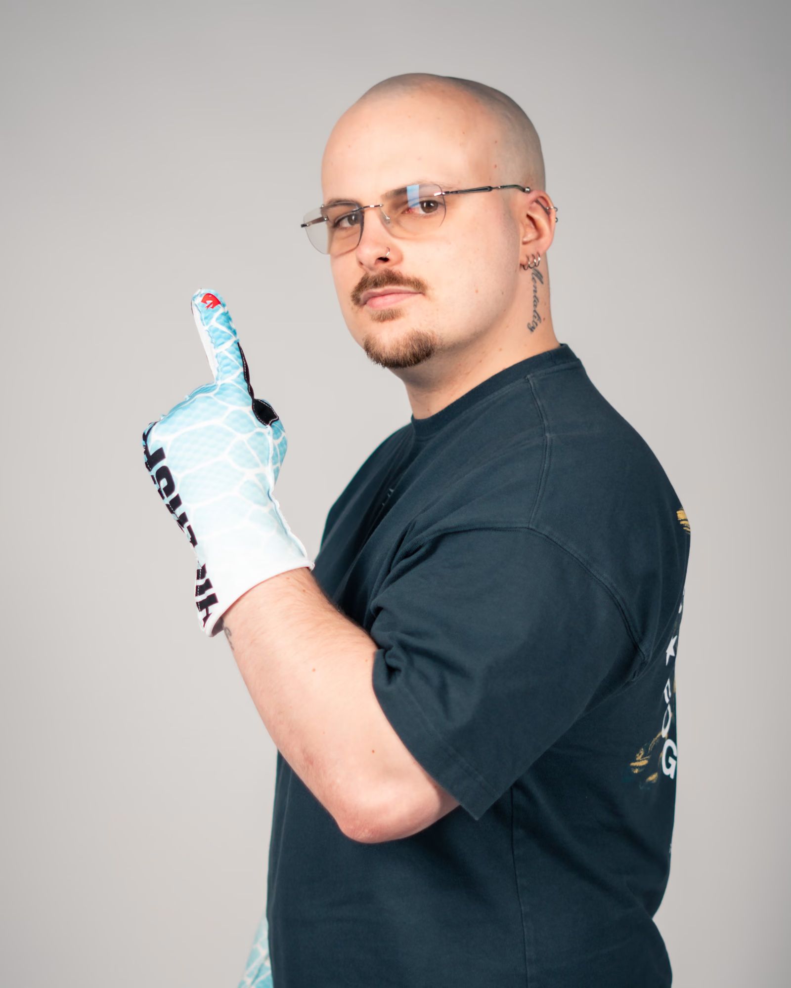 Nic in the V2 Ice Serpent gloves, one finger raised.