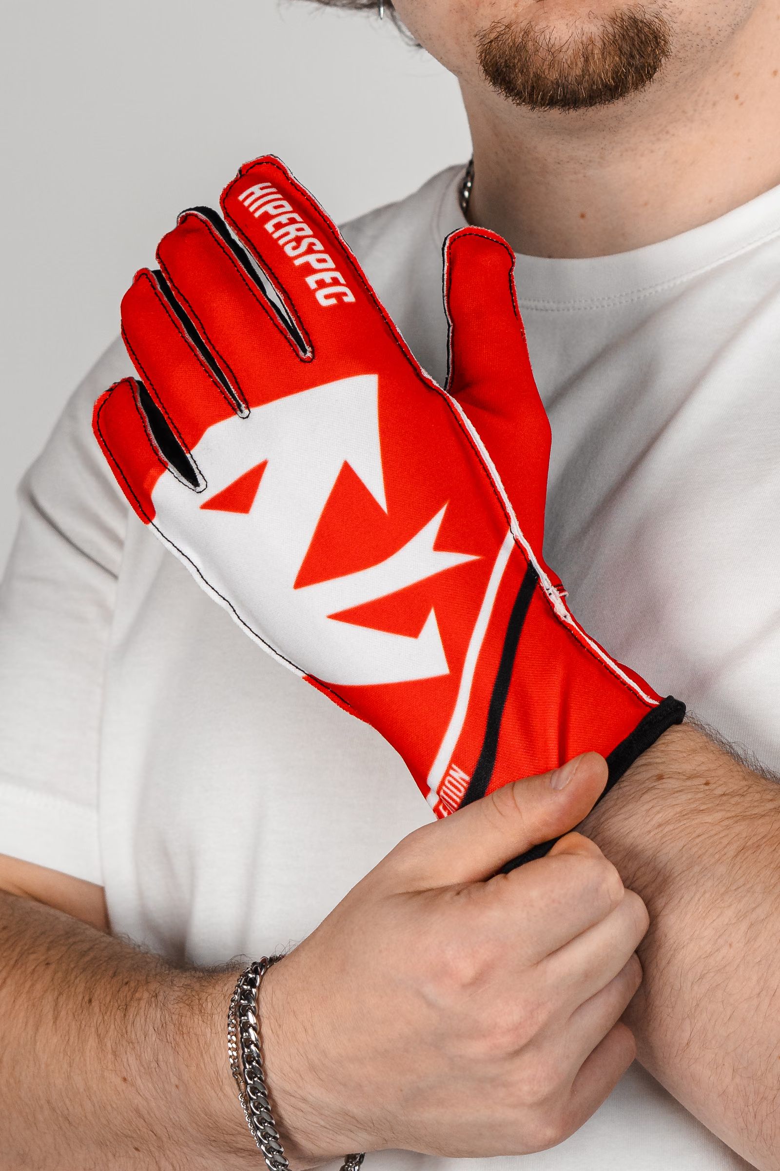 Pulling on a Crimson glove, showing the medium-length cuff at the wrist.