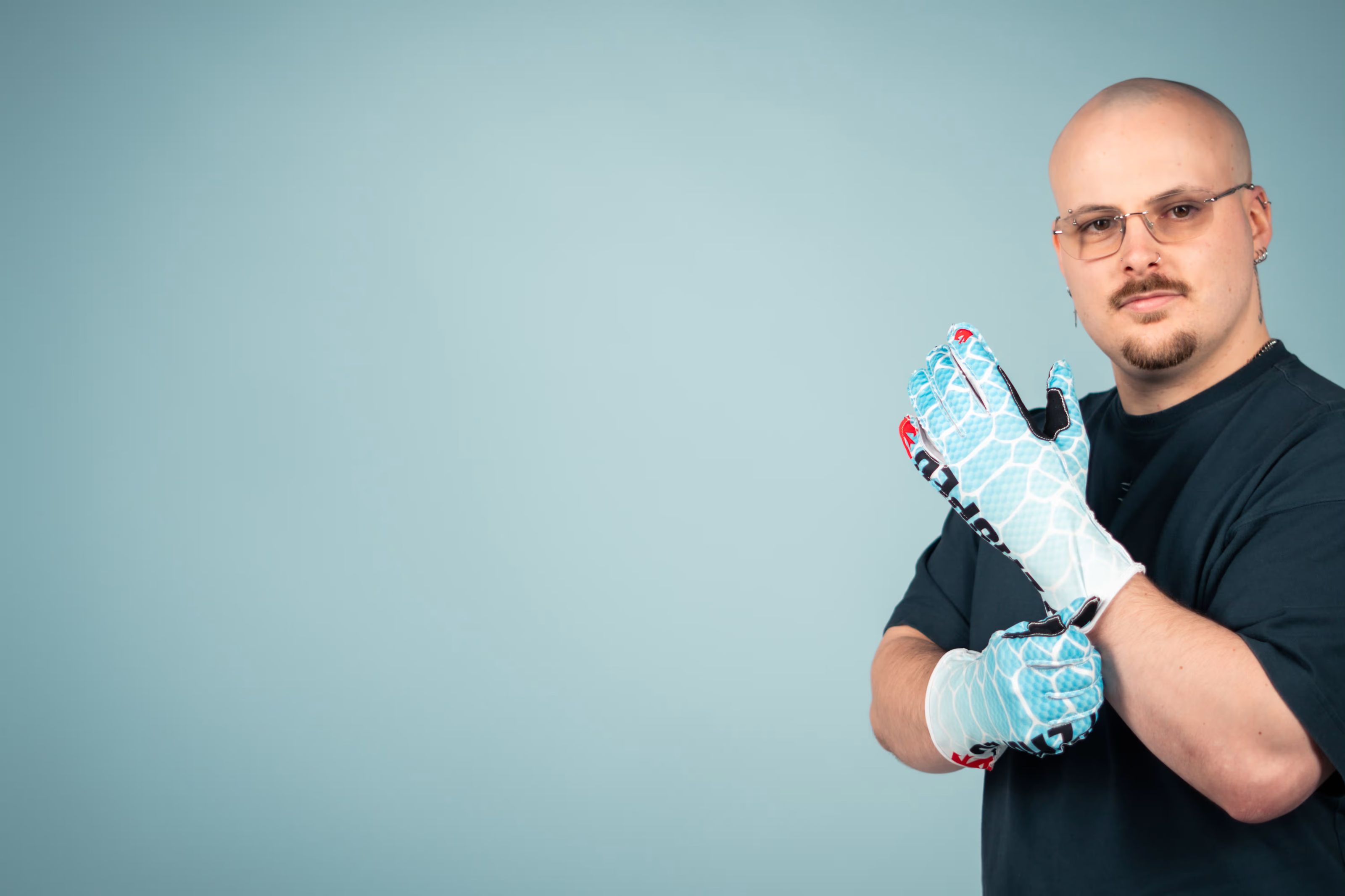 Nic pulling on a pair of V2 Ice Serpent gloves.