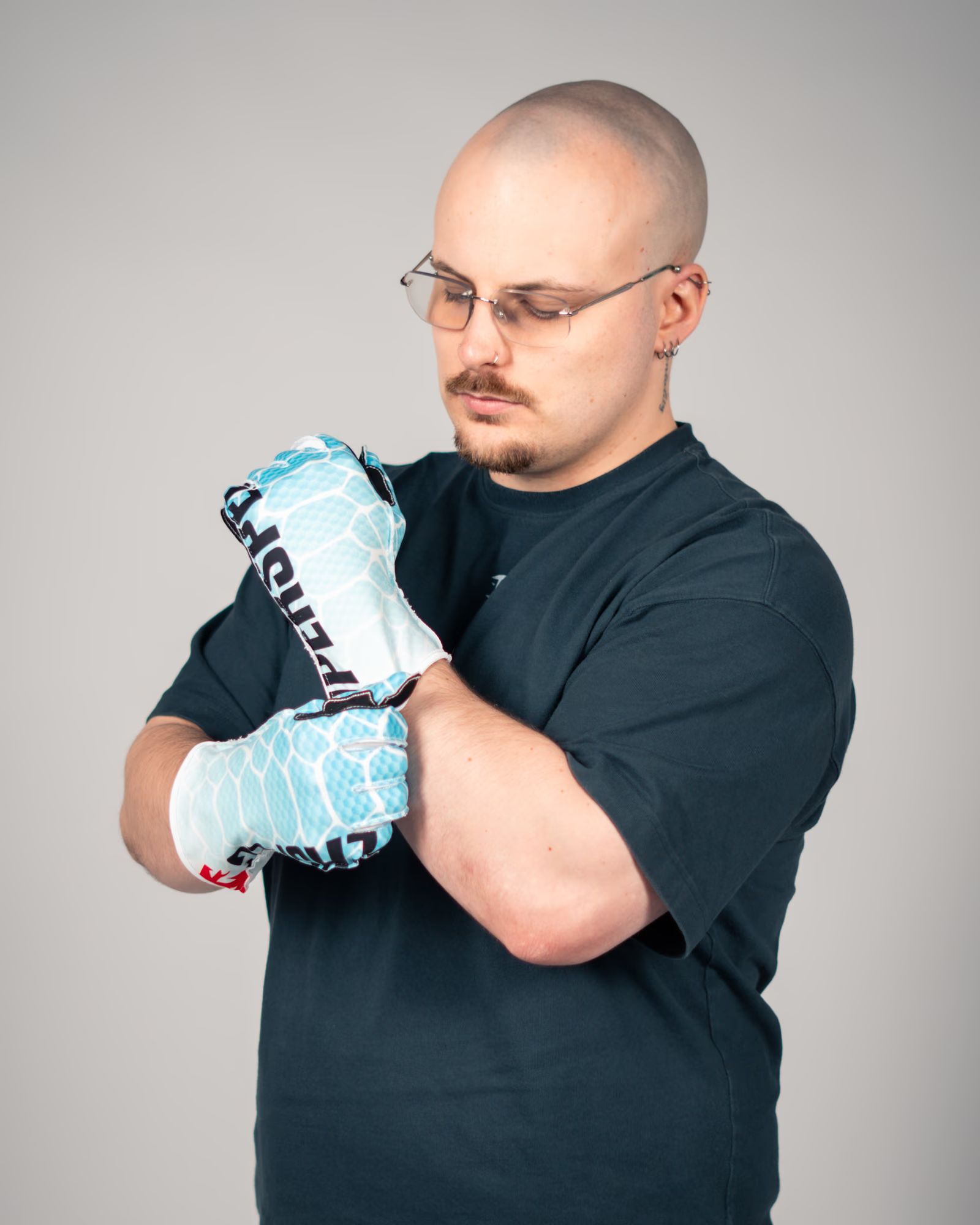 Pulling on a V2 Ice Serpent glove, showing the medium-length cuff at the wrist.